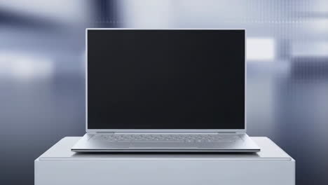 silver laptop with blank screen on pedestal