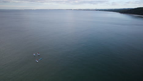 teenagers relaxing on sup boards in a lake