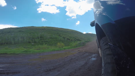 SUV-doing-a-donut-in-a-mud-pit-and-then-driving-through-a-creek-at-high-speed