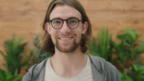 portrait of cute young geeky man wearing glasses smiling happy enjoying relaxed lifestyle