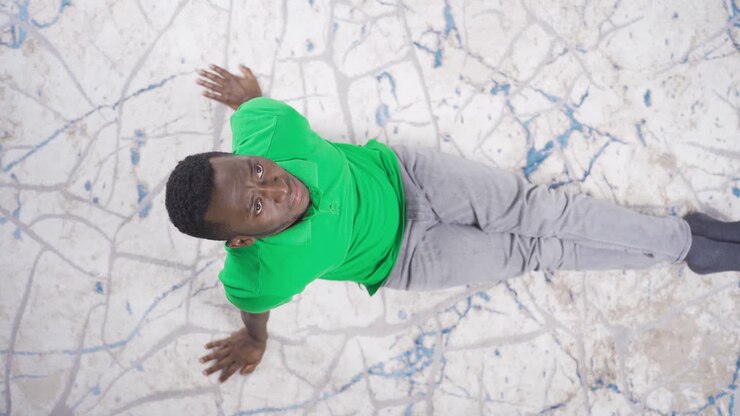 Top view of sad lonely black man sitting on floor at home stressed and tired.