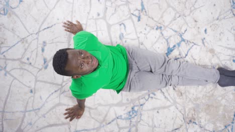 Top-view-of-sad-lonely-black-man-sitting-on-floor-at-home-stressed-and-tired.