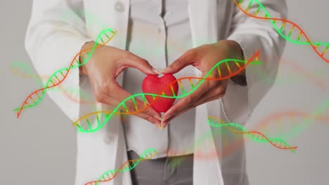 animación de cadenas de adn sobre una doctora biracial con corazón