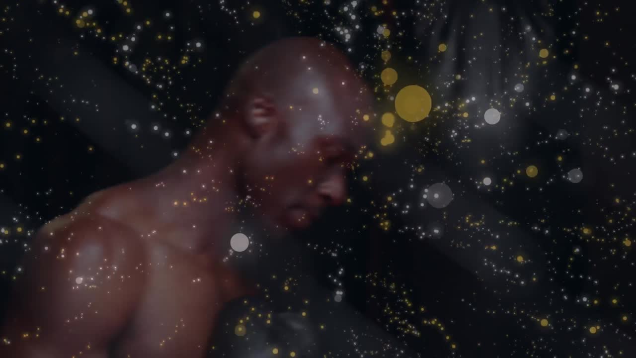 Animation of glowing light over male boxer exercising in gym