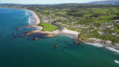 epic 4k drone view of the shoreline of brighton in new zealand at sunny day