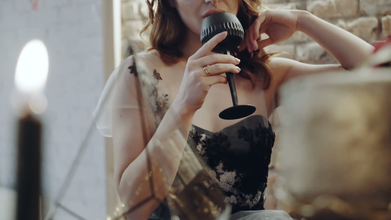 Woman drinking wine. Portrait of woman in evening dress drinking glass of alcohol in the restaurant