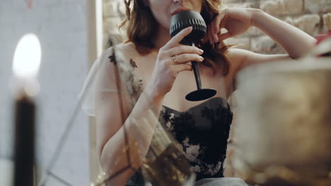woman drinking wine. portrait of woman in evening dress drinking glass of alcohol in the restaurant