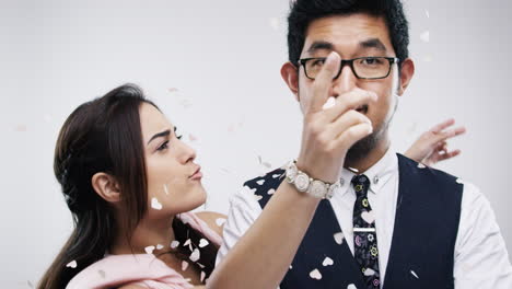 couple celebrating with heart confetti