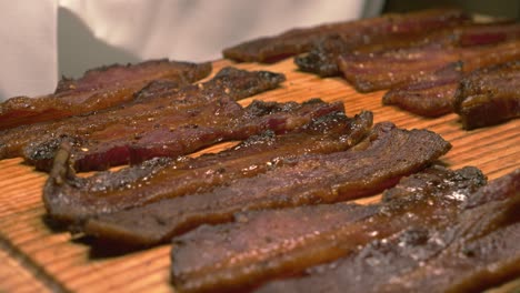 beef strips placed under heater at brazilian restaurant