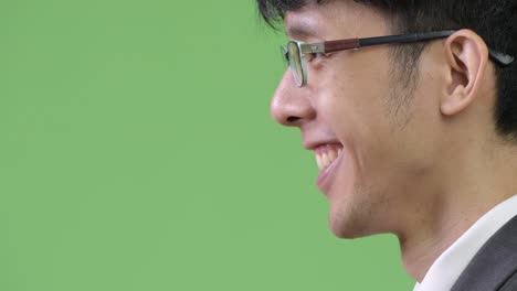 profile view of young asian businessman smiling