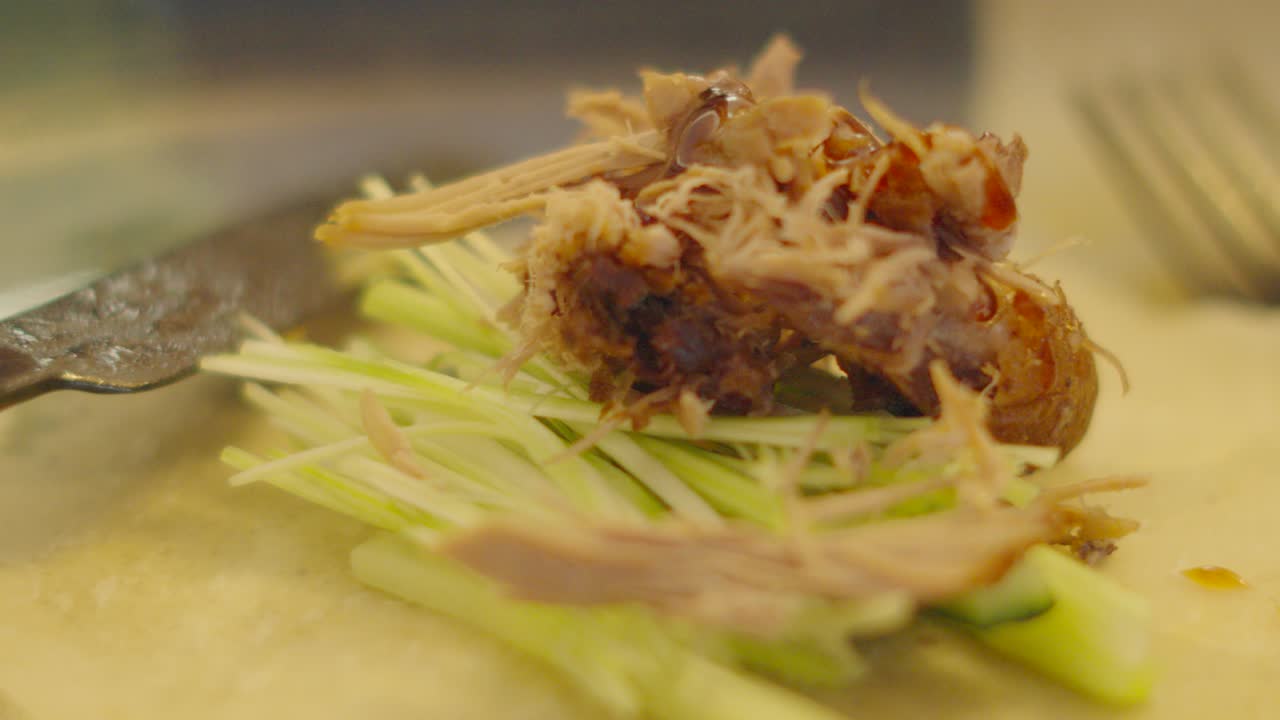 Chinese Crispy Duck Pancake Being Dressed with Hoisin Sauce with Spring Onions and Cucumber. Elegant High Quality Food Footage. Ready to Wrap and Eat