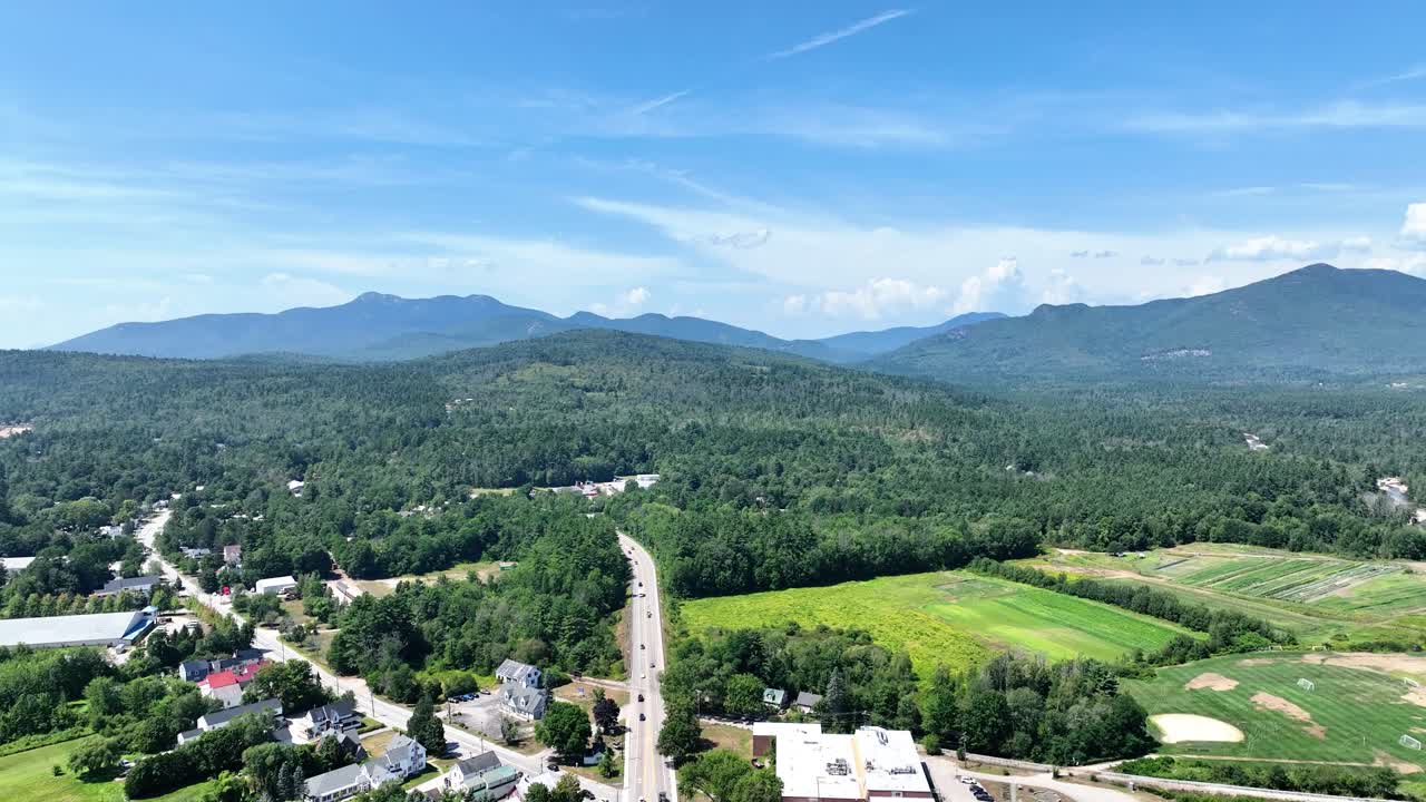 Drone view of Conway, New Hampshire and the Kancamagus highway with the White Mountains in the distance