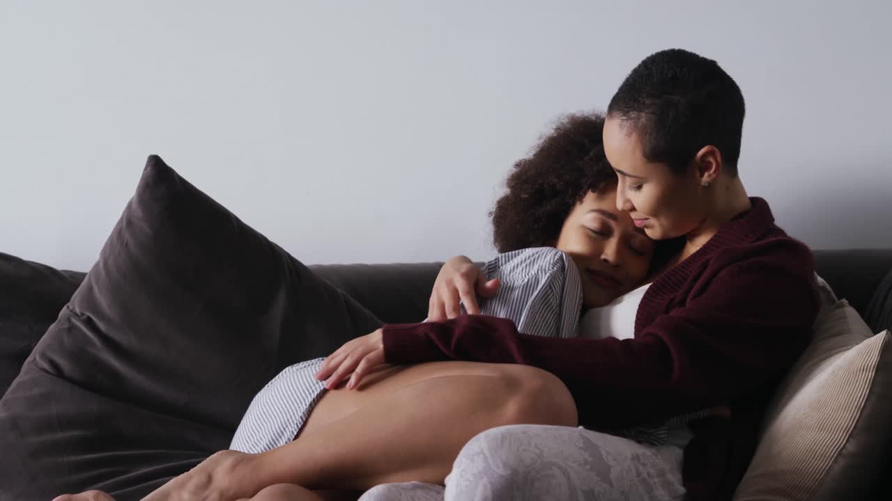Lesbian couple romancing in living room