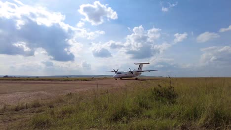 small airplane on grass runway in africa