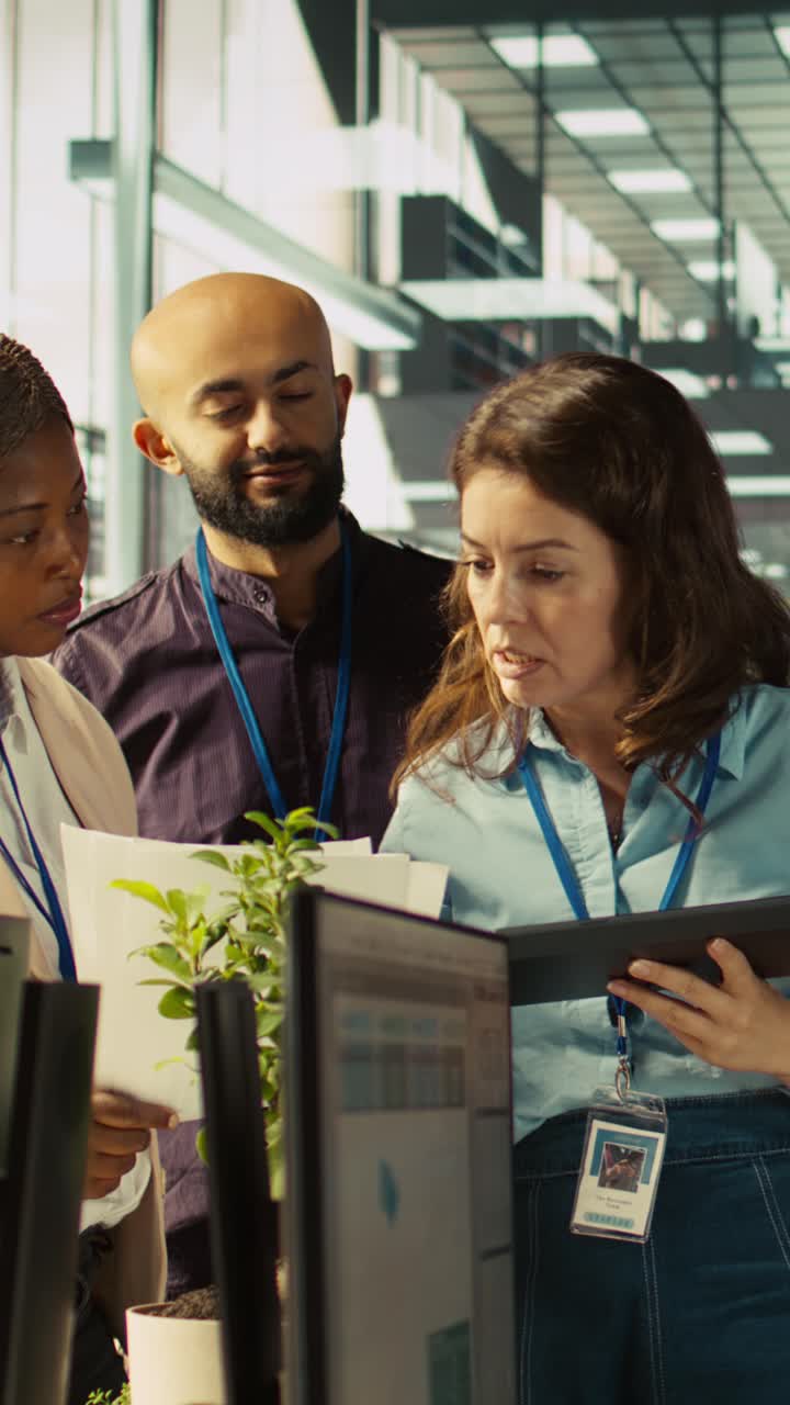 Vertical video Employees in office working together on finishing project