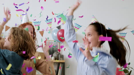 children throwing confetti and jumping