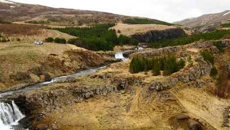 aerial view over wild river and waterfall in beautiful scenery - iceland