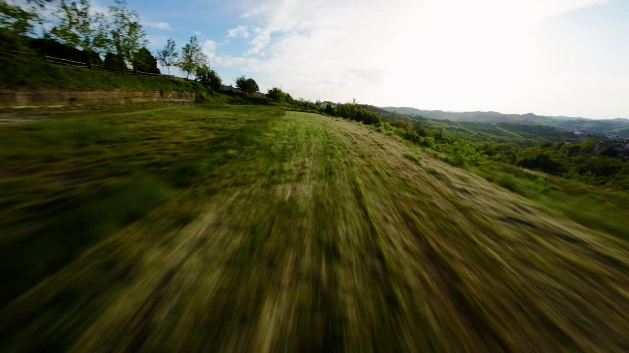 Flying low over a scenic landscape, FPV drone cruising through lush nature