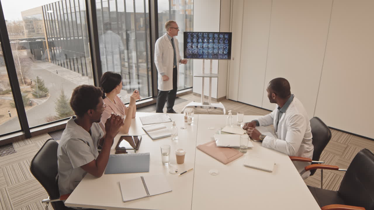 Medical Team Analyzing Brain Scans in a Conference