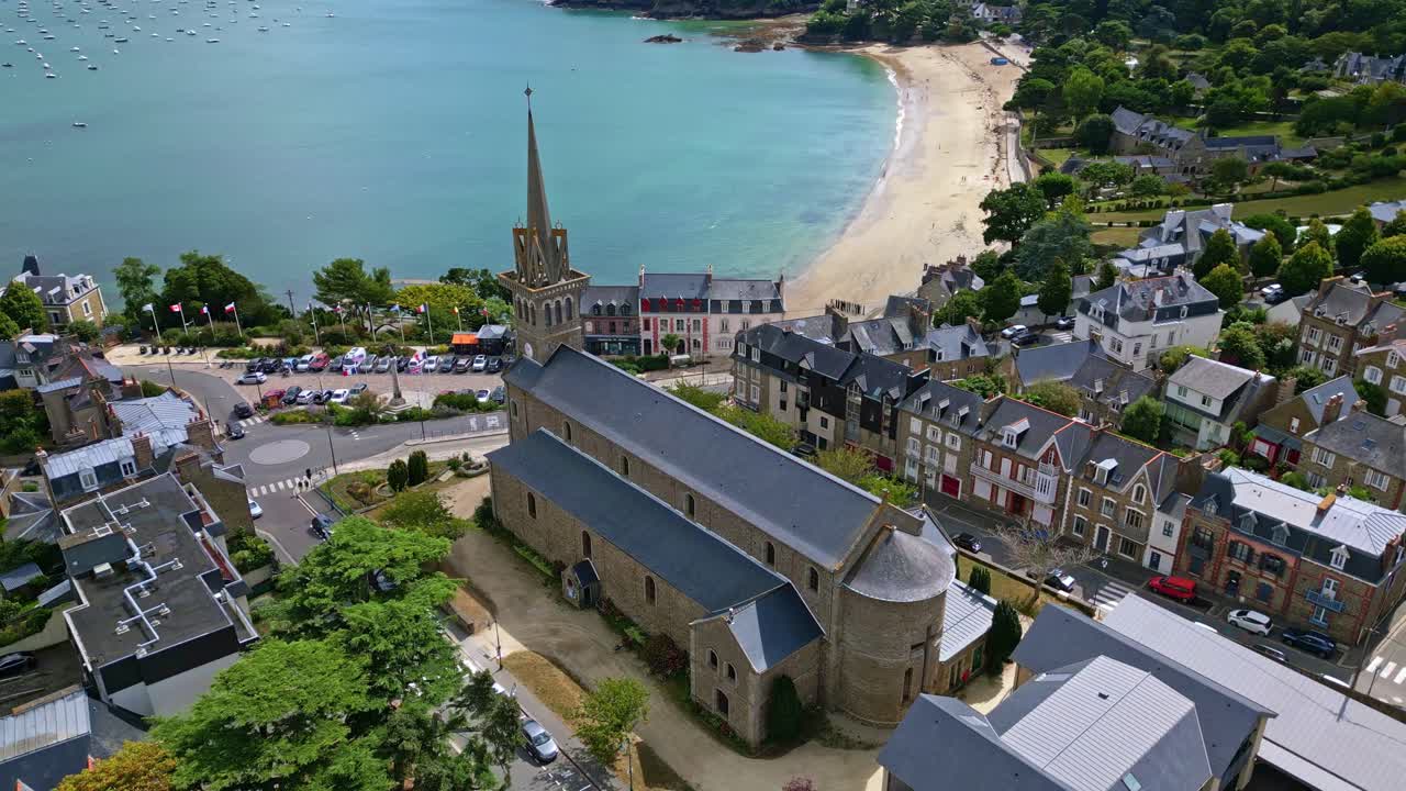 Notre Dame d'Emeraude church, sandy beach and marina in Dinard, France. Aerial drone
