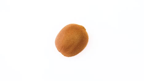 fresh organic kiwi rotating on white background - stop motion