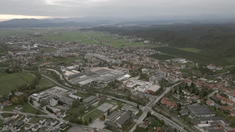 drone view over kamnik, slovenia: charming town nestled between rolling hills and the majestic alps, with red-roofed buildings, narrow streets, and lush green landscapes