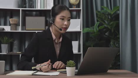 Enthusiastic-businesswoman-utilizing-laptop-for-video-conference.