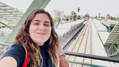 young commuter waiting at a train station overpass