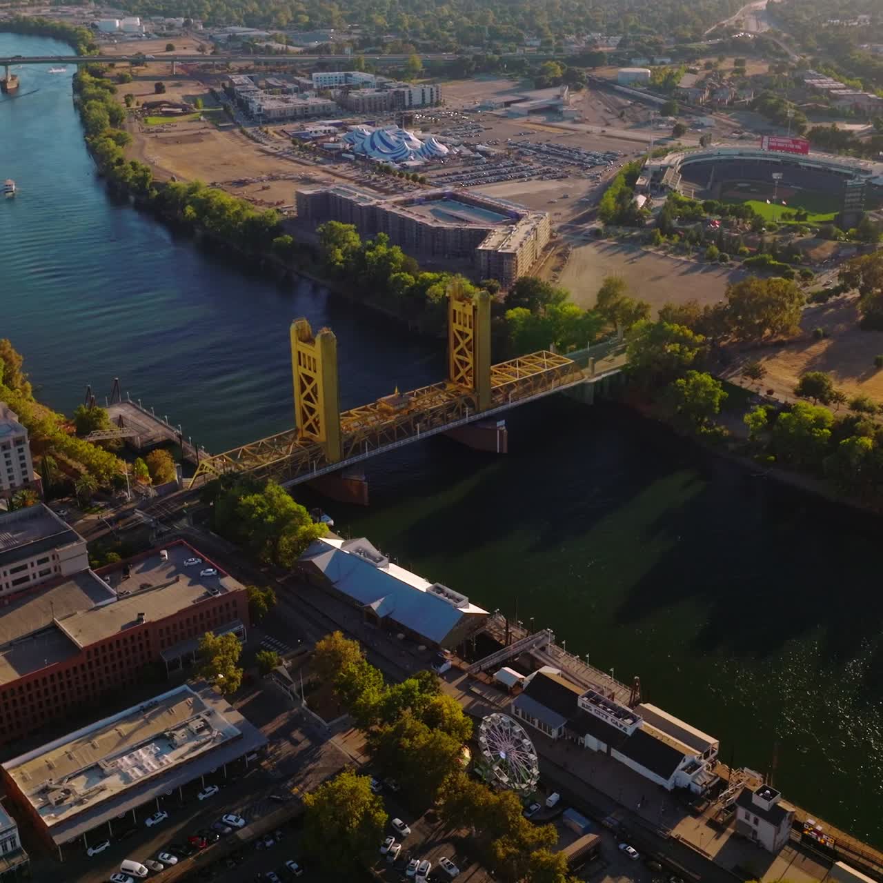 Beautiful view of Sacramento River with bridges over it. Drone descending over the lovely city on sunny day