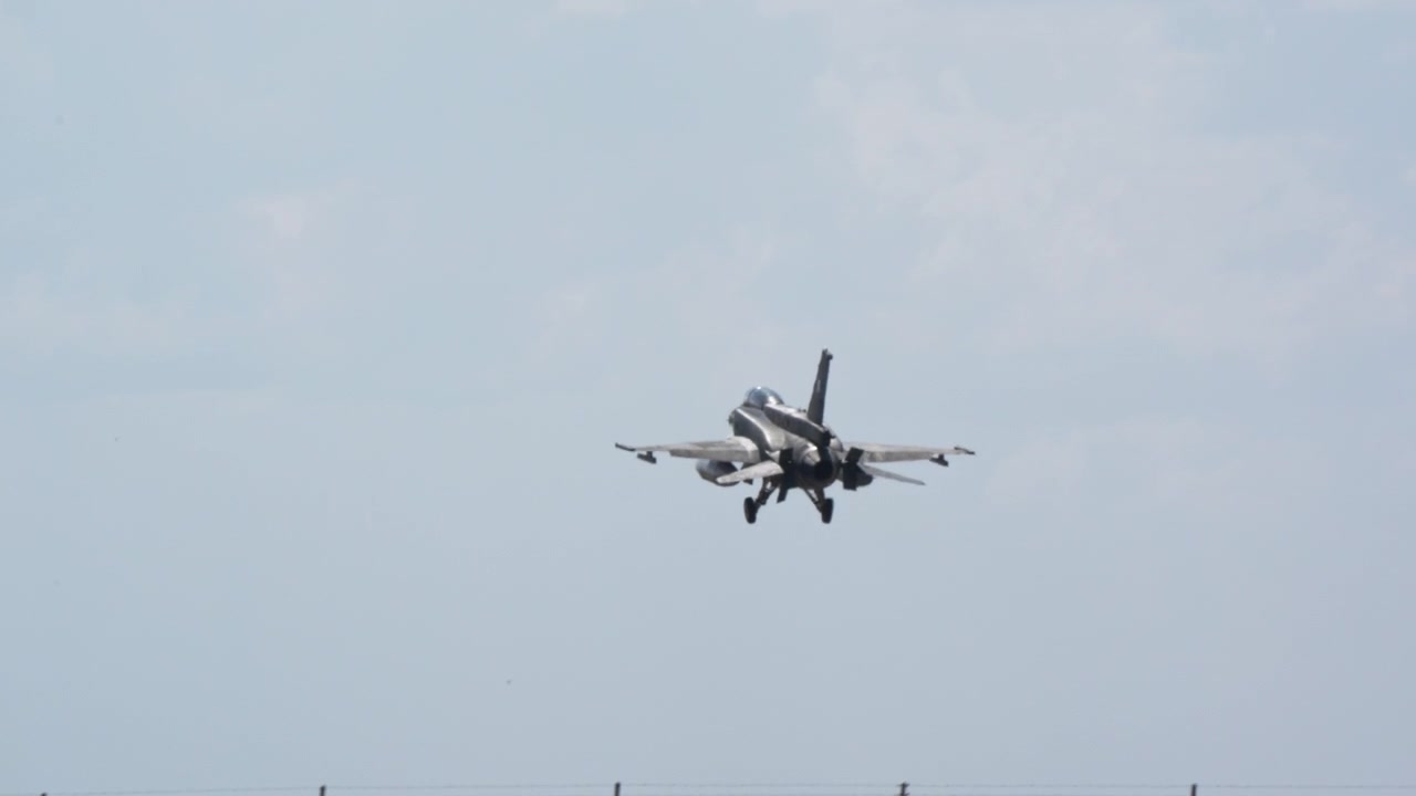 Fighter jet on approach low over airfield field