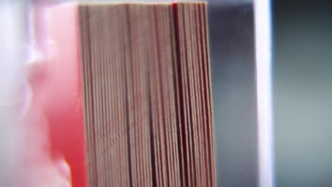 macro shot of a pile of visit cards in stock, red card, super slow motion, full hd, tilt down smooth movement