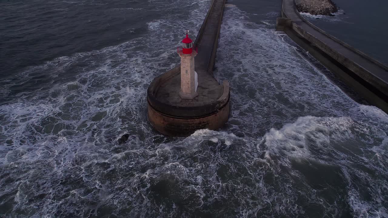 Moody aerial orbiting the Felgueiras Lighthouse at the churning Atlantic mouth of the Douro just after sunset, blue hour light reflecting off swirling water and historic stone jetty, Portugal, Europa