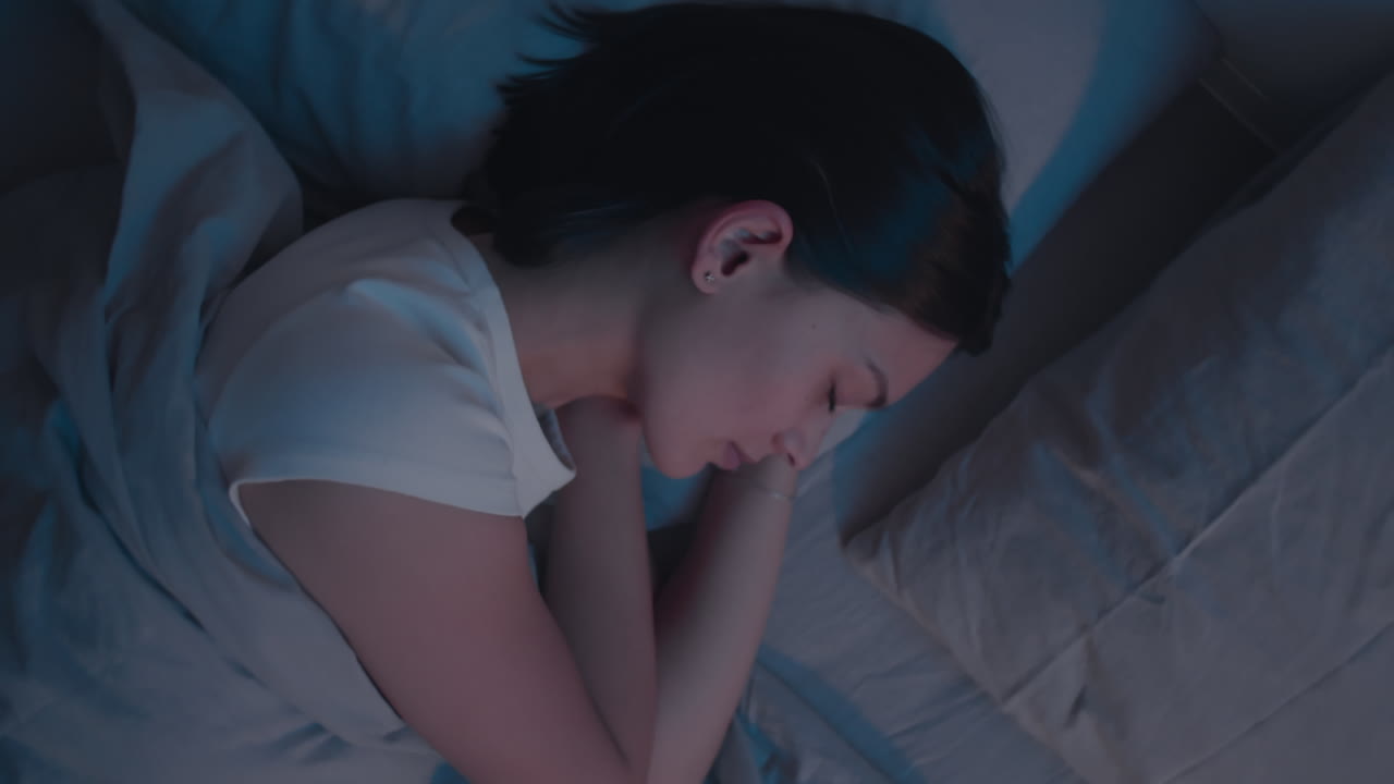 Woman Sleeping in Bed during Night