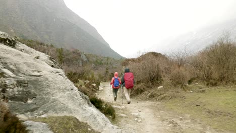 couple walking among the mountains of nepal.