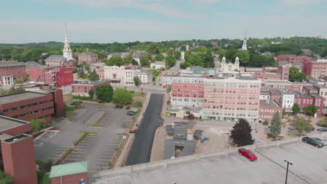 aerial view over lush bangor, maine, highlighting downtown, church, and garage