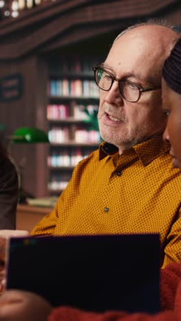vertical video adult students examines information during a lecture in a university library