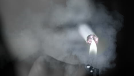 Hand lighting a cigarette