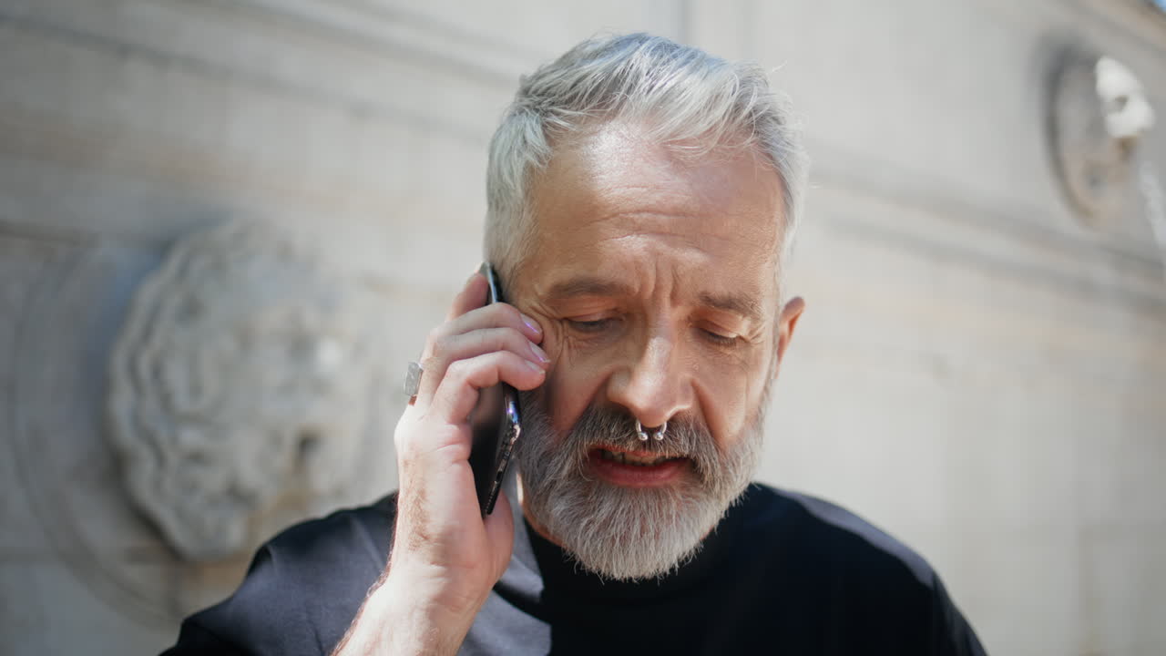 Stylish man talking cell closeup. Serious mature businessman having conversation