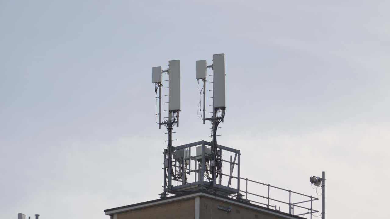 5G Infrastructure Mast on Building using High-Frequency Radio Waves to Provide High Connectivity Internet with Low Latency and High Capacity. Modern Technology Equipment. Connecting the World. UK