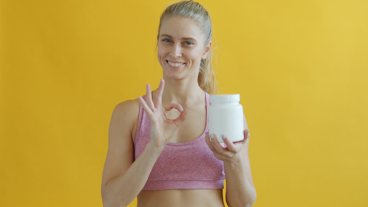 Woman Holding a Protein Shake Container