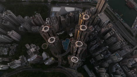 residential high rise buildings in dense urban development, with pool, the belcher's, sai wan, hong kong island, cinematic top down aerial