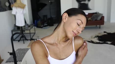 woman applying skincare in a studio