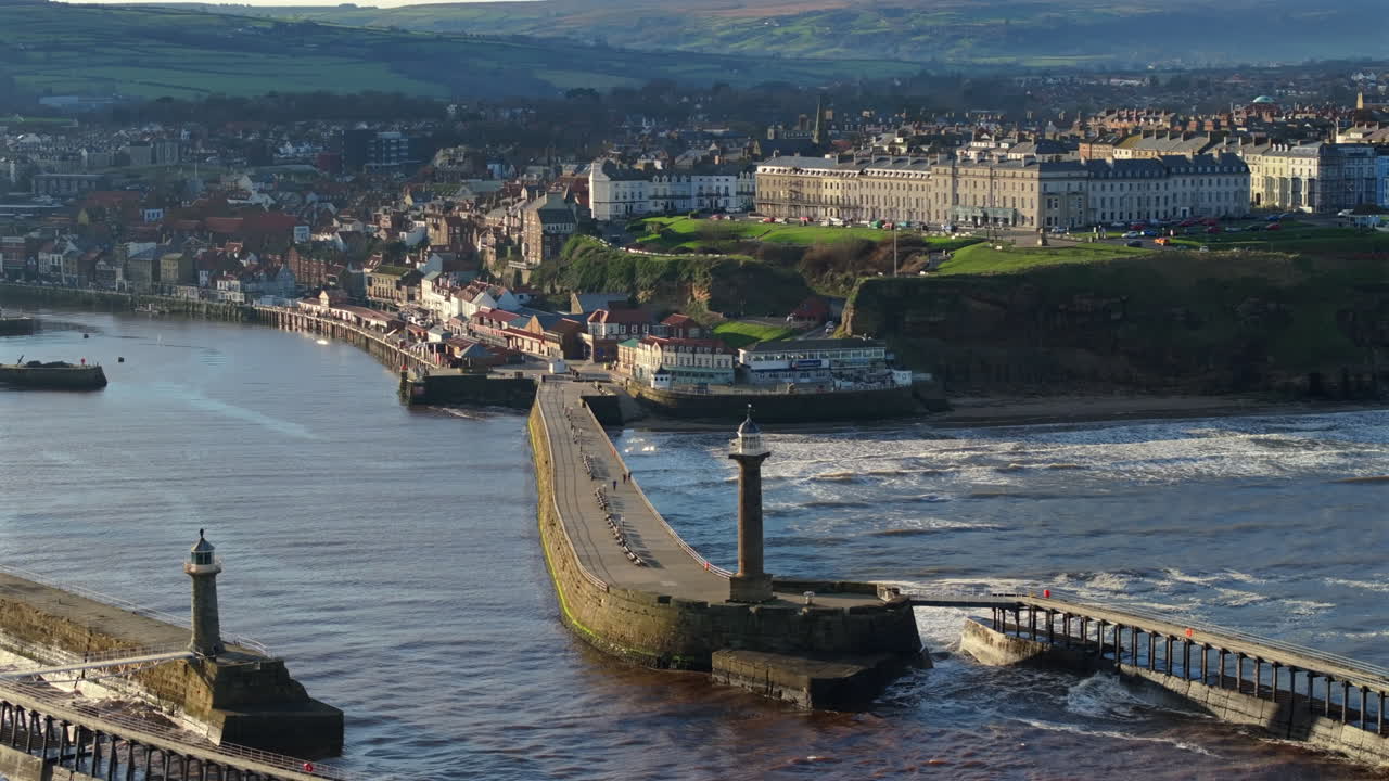 Establishing Drone Shot of Whitby looking down River and Pier High Tide