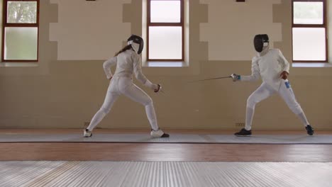 Fencer-athletes-during-a-fencing-training-in-a-gym