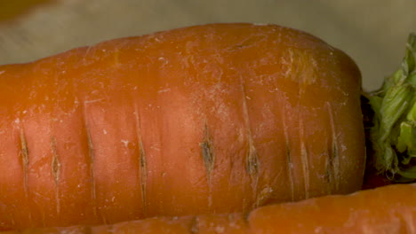 crunchy, crispy, whole, ripe carrots waiting to be peeled