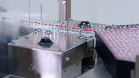 pharmaceutical production line. medical vials on automated production line