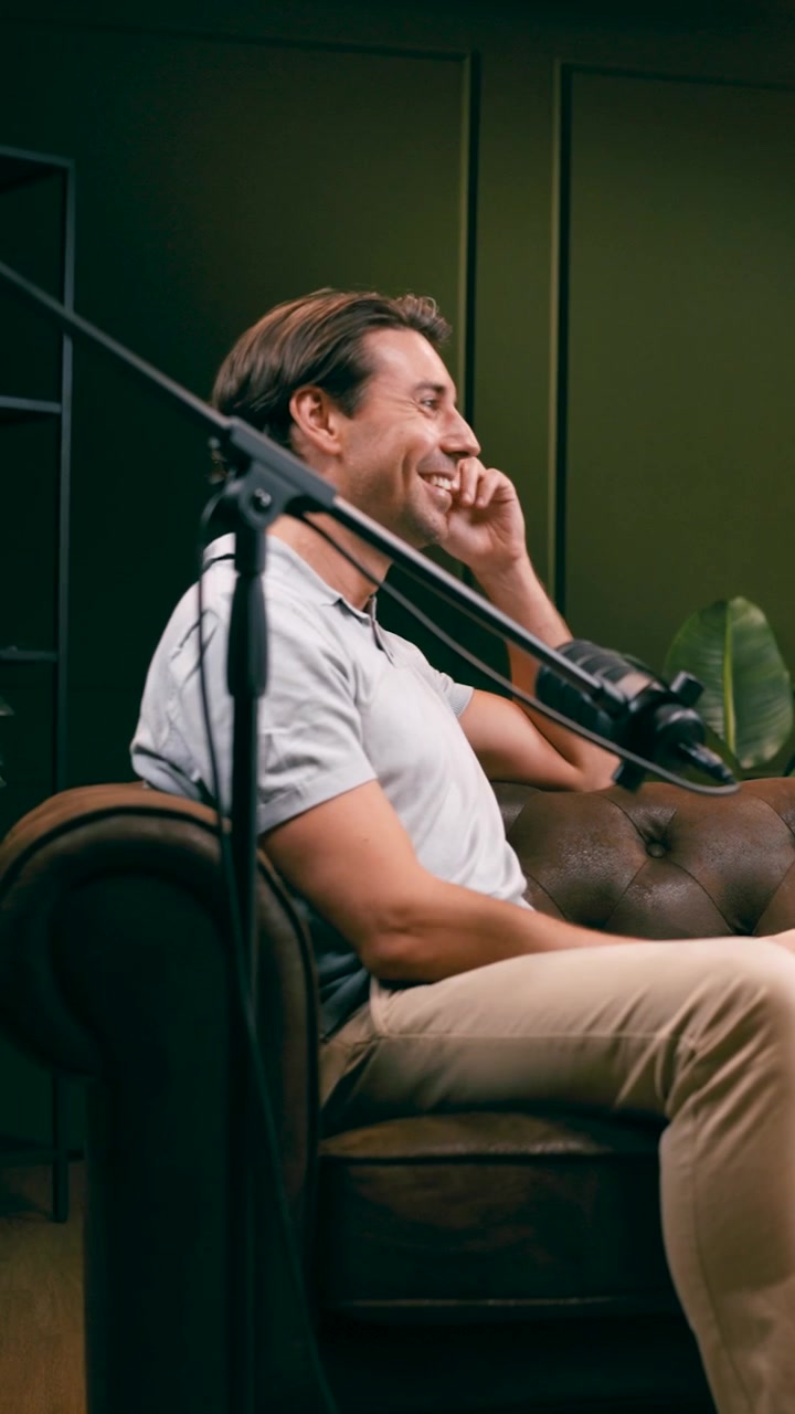 Man Sitting on Leather Sofa During Podcast Interview