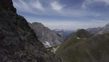 Hiker-running-carefully-down-the-side-of-mountain-Rockies-Kananaskis-Alberta-Canada