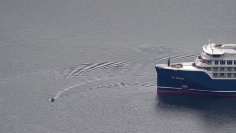 Small-pleasure-craft-crossing-bow-of-cruise-vessel-SH-Diana-from-Swan-Hellenic