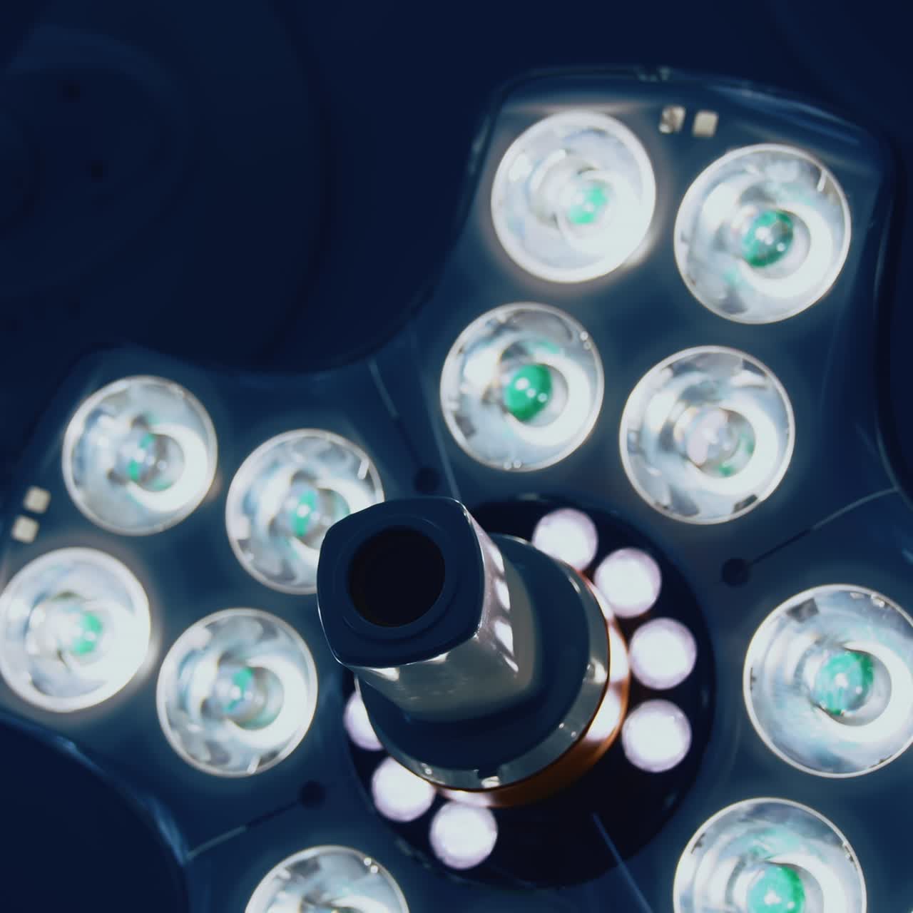 Light equipment on ceiling in operating room. Modern medical lamp with different bright lamps shining. Close-up